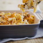 A family dinner winner, baked bacon mac and cheese recipe. This recipe creates the perfect rich and gooey macaroni and cheese with the game-changing bacon crumb topping. #familyfood #familydinner #bacon #macaroni #cheese #macandcheese #italianamerican