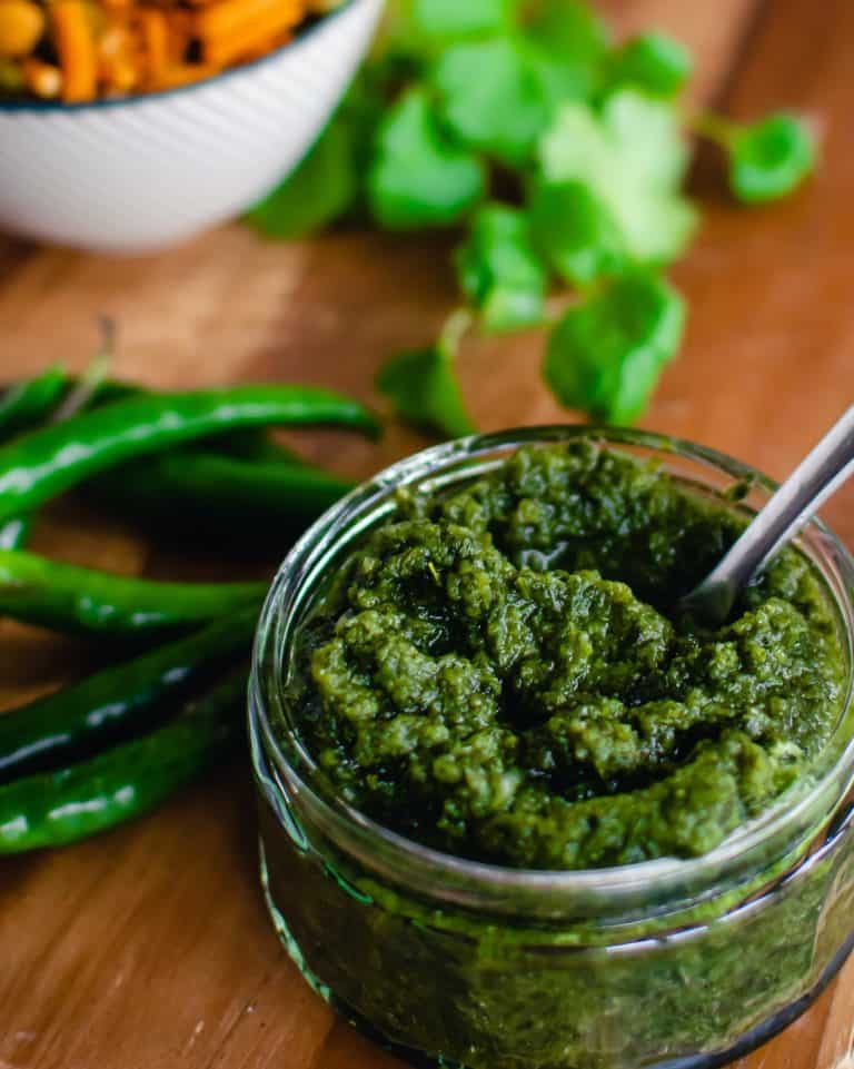 cilantro mint chutney in a glass bowl with spoon