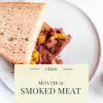Montreal smoked meat piled high on rye bread with yellow mustard and dill pickles