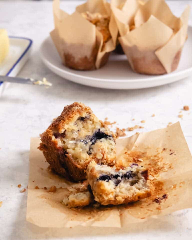 Split wild blueberry muffin showing tender crumb and bursting blueberries